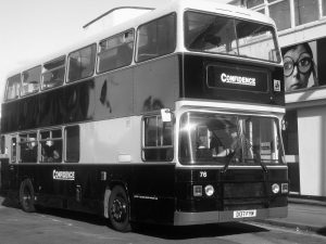 Black and white photograph of double-decker bus clearly signed “Confidence"